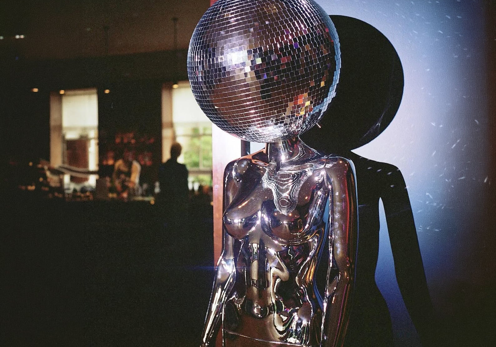 Chrome mannequin with a mirror ball head, cover image for why energetic health is the new sexy