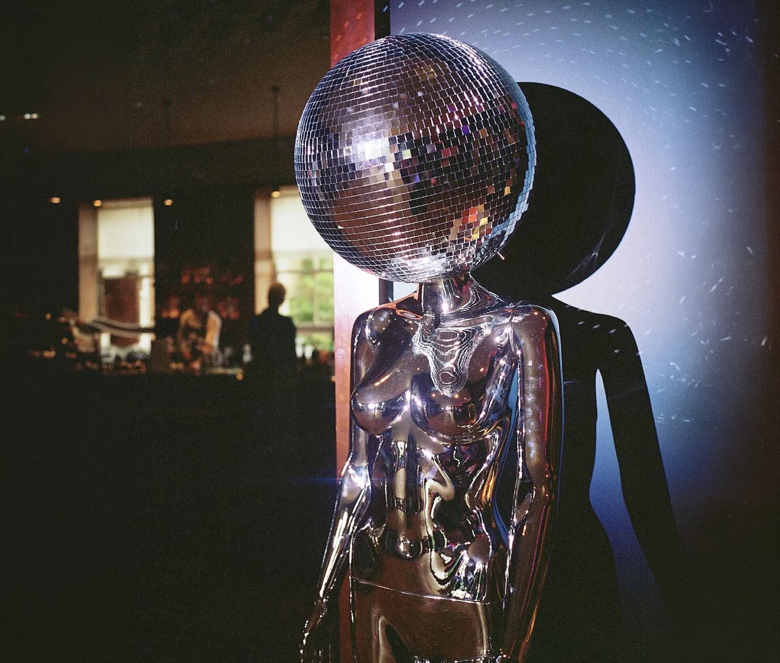 Chrome mannequin with a mirror ball head, cover image for why energetic health is the new sexy